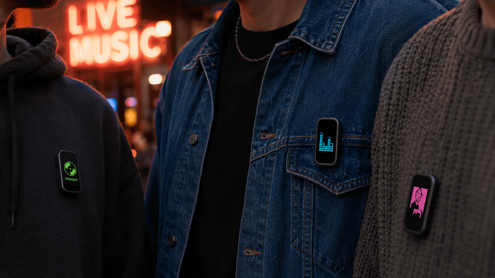 Three people outside a live music venue, each wearing a MoodPin showing a different music screen